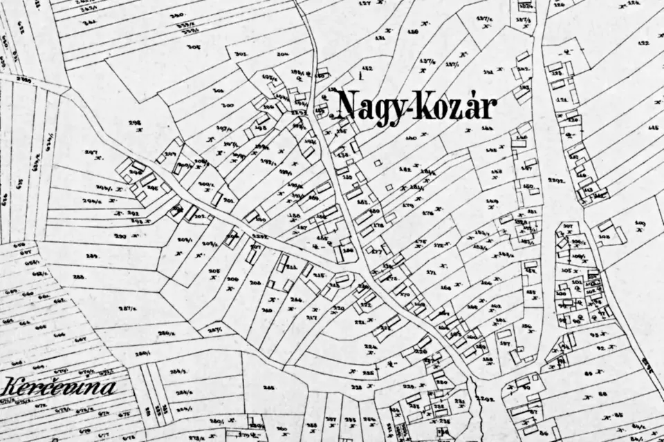 Detail of a black and white cadastral map showing numbered land parcels, streets and houses around the village of Nagykozár
